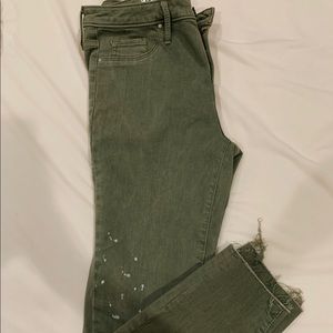 Green skinny jeans with splatter paint